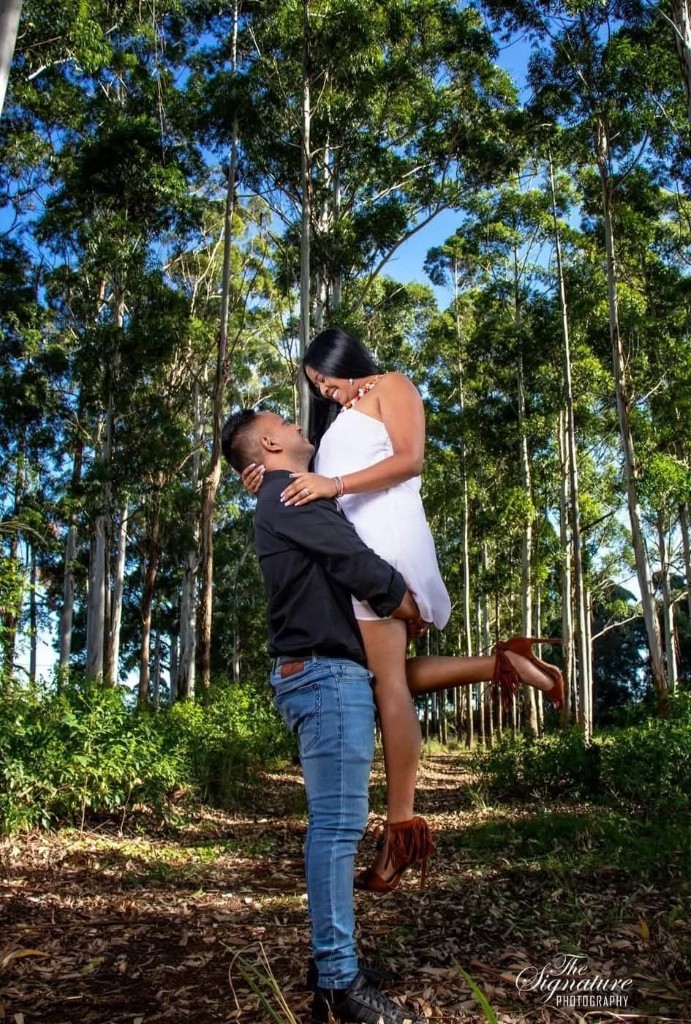 Renesh lifting Chanelle in a white dress in the forest